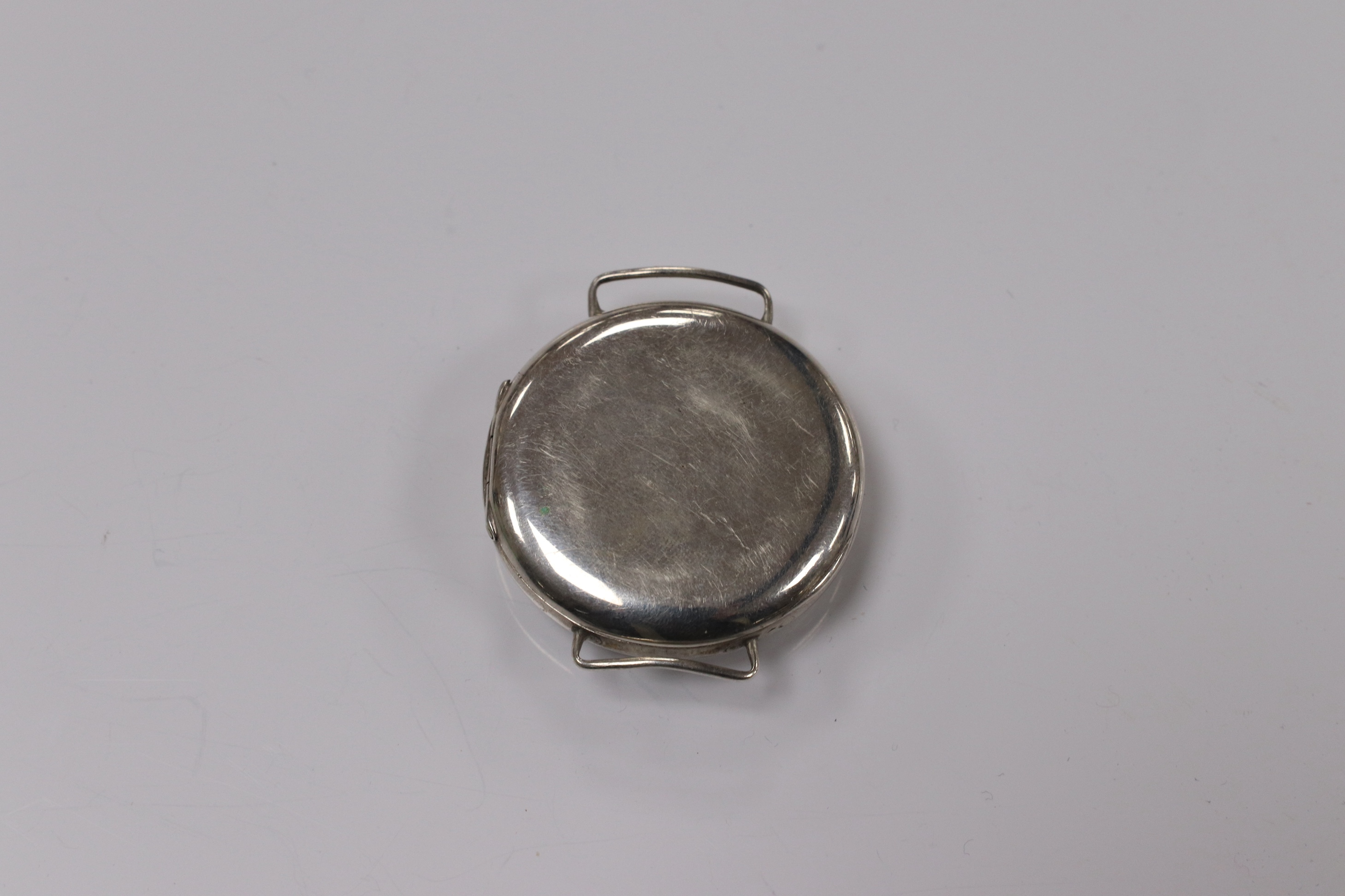 A George V silver manual wind trench watch with 'telephone dial' shrapnel guard, case import marked for London, 1917, case diameter 35mm, lacking winding crown. No strap. Condition - poor